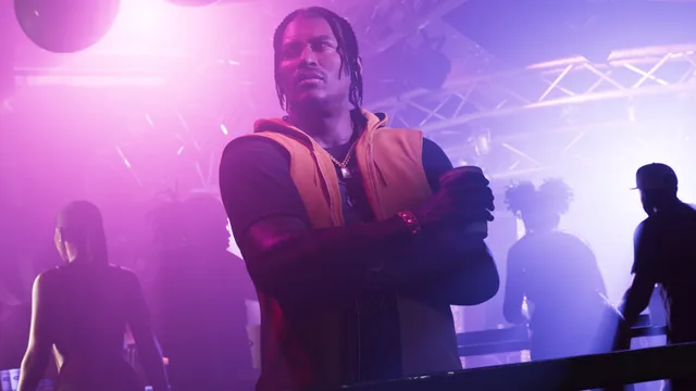 Dre’Quan with crossed arms in a brightly lit club