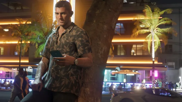 Jason leaning against a tree, looking at his phone