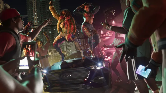 The Real Dimez dancing on a car hood surrounded by people holding up phones