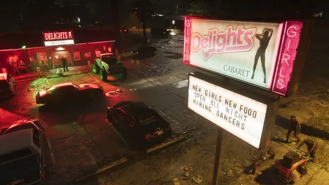 The Delights cabaret sign over a parking lot at night